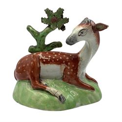 Early 19th century Staffordshire Pearlware model of a Deer, with tree bocage behind, H13.5cm