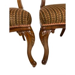 Set six Victorian mahogany dining chairs, the carved cresting and back rail over upholstered seat, raised on cabriole supports 