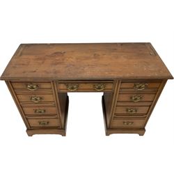 Edwardian walnut twin pedestal knee-hole desk, rectangular top with moulded edge, fitted with nine drawers with reeded fronts, on plinth base