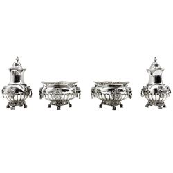 Early 20th century silver double condiment set of circular design with gadrooned borders, lion mask ring handles and masks of the Tyne God and on claw feet comprising pair of salts , pair of pepperettes and pair of mustard pots London 1915 Makers Mark B & S and with makers mark of Reid & Sons, Newcastle on Tyne 40oz 