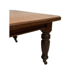 Late Victorian mahogany dining table, rectangular canted and moulded top, telescopic extending action with two additional leaves, on turned and reed moulded supports, brass and ceramic castors 