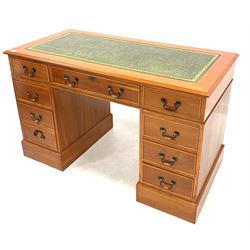 Late 20th century yew twin pedestal desk, green tooled leather inset writing surface over one long and two banks of four short graduating drawers, raised on plinth base W123cm, H76cm, D61cm