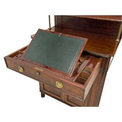 In the manor of George Bullock - early 19th century mahogany chiffonier writing desk, raised back with shelf on brass pillar supports, moulded rectangular top with concaved corners, single frieze drawer with moulded edge, fitted with sliding and hinged leather inset writing surface and small lidded compartments, the lock stamped 'GR J. Bramah's Patent, Shaw & Crane', with circular brass handle plates engraved with trailing bellflowers, double cupboard enclosed by figured panelled doors, concaved uprights to match the top, on square spade feet, 