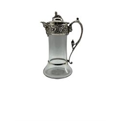Late Victorian silver mounted glass claret jug with Sphinx lift, Bellarmine mask spout, embossed flowers, scroll handle with Bacchus and leaves H25cm Sheffield 1900 Maker Robert and Belk 