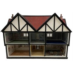 Large Tudor style dolls house, with painted and brick paper facade, balustraded balcony running the entire front, a walled garden to the front and open back revealing six rooms over two levels, W88cm, H63cm, D58cm 
