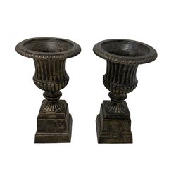 Pair Victorian design cast iron Campana shaped garden urns with base, in black and gilt finish