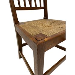 Pair of 19th century country elm chairs, plain rectangular cresting tail over pierced back, drop in rush seats, on square tapering supports joined by plain stretchers