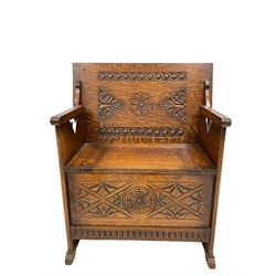 20th century oak monks bench, the carved metamorphic top over box seat with hinged lid, raised on panel end supports W77cm