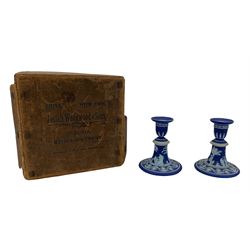 Pair of early 20th century Wedgwood dark blue Jasperware candlesticks, sprigged with classical figures, with their original Josiah Wedgwood & Sons box