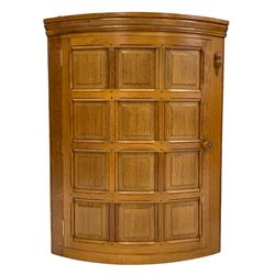 'Beaverman' oak bow front corner cupboard, moulded cornice over bowed panelled door, the upright carved with beaver signature, the interior fitted with two shelves, by Colin Almack of Sutton-under-Whitestonecliffe