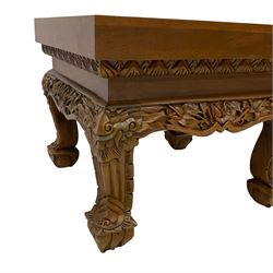 Carved hardwood coffee or lamp table, the square top carved with flower heads and foliage