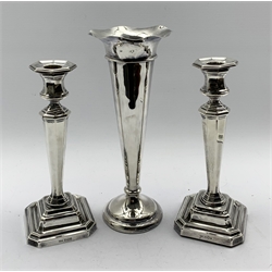 Pair silver table candlesticks with panel sided tapering stems and stepped square bases H21cm Sheffield 1915 Maker James Dixon & Sons and a silver trumpet shape vase with crimped rim H 24cm, marks rubbed but Maker Barraclough & Sons