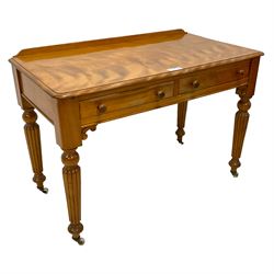 Victorian satinwood side table, raised back over rectangular top with moulded edge, fitted with two drawers over c-scroll brackets, on turned and reeded supports with ceramic castors