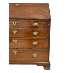 George III mahogany bureau, fall-front enclosing fitted interior,  above four graduating cockbeaded drawers, each with brass handles, raised on bracket feet