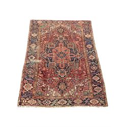 Persian ground rug, the red field with geometric design enclosed by a navy border 315cm x 235cm