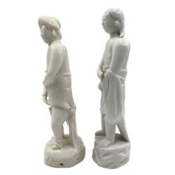 Matched pair of Qing dynasty 18th century Chinese Blanc de Chine porcelain 'Adam and Eve' figures, each figure partially draped in robes, on rocky plinths, H23.5cm