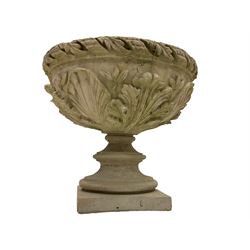 Composite stone urn, foliate and ribbon cast edge over a shell and floral relief