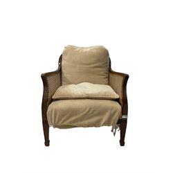 20th century cane back chair with beige cushions, raised on peg feet 