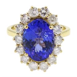 18ct gold oval tanzanite and round brilliant cut diamond cluster ring, hallmarked, tanzanite approx 4.50 carat, total diamond weight approx 1.00 carat