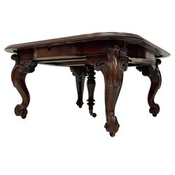 Large 19th century mahogany dining table, rectangular top with rounded corners and moulded edge, telescopic extending action with three additional leaves, on scroll carved cabriole supports with recessed brass castors, central turned support
