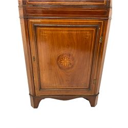 Edwardian inlaid mahogany corner cabinet, projecting cornice over astragal glazed door enclosing two shelves, the base fitted with single panelled door, the facia with foliate satinwood inlay and ebony stringing, raised on bracket feet