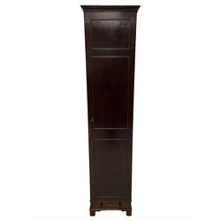 George III mahogany narrow cupboard, the projecting cavetto cornice over a single door with applied moulding, enclosing single slatted shelf, fitted with drawer to base with turned handles, lower moulded edge over bracket feet