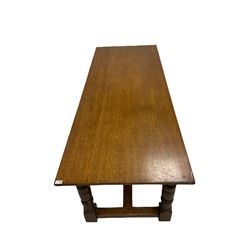 Oak refectory table, the rectangular top over carved frieze, raised on turned and square supports, united by a stretcher W199m, H75cm, D76cm