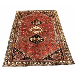 Persian Kashgai red ground rug, with a formal geometric design and bordered 258cm X 172cm