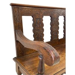 Late 19th century oak hall bench, the cresting rail carved with lunettes and supported by three carved shaped splats, rectangular moulded seat over shaped apron carved with scrolled foliage, on turned supports 