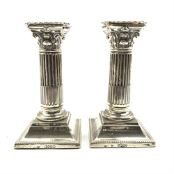 Pair of Victorian silver Corinthian column candlesticks on square bases H15cm London 1888 Maker Martin Hall & Co, only one sconce hallmarked with Sheffield assay mark 