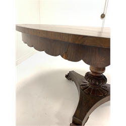 William IV rosewood tilt top breakfast table, the circular top over shaped apron, raised on baluster turned and leaf carved pedestal leading to trefoil platform base and scrolled feet with castors 