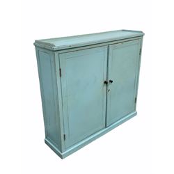 Late 19th/ early 20th century painted pine kitchen larder cupboard, panelled doors enclosing two shelves, raised on a skirted base W140cm, H127cm, D38cm