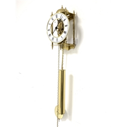 Hermle brass skeleton weight driven wall clock, eight day movement with passing strike to exterior bell, white enamel dial with Roman chapter ring