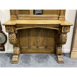 Pair Gothic style oak console table with mirror, pointed ogee arch decorated with trailing scrolled foliage, the tracery uprights with crocketed pinnacles, moulded reverse break-front top supported by two scrolling supports carved with foliage and berries, pieced with quatrefoils, panelled back with cusped pediments