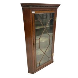 Georgian and later oak corner cabinet, the dental cornice over one glazed door with astragal design enclosing interior with three fitted shelves W76cm