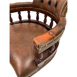 Chesterfield style captain's chair, upholstered in buttoned back brown leather, raised on a swivel base with castors 