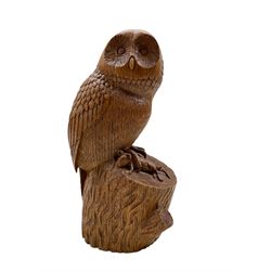 Carved oak model of an Owl standing on a naturalistic rocky base, holding a mouse in its talon, signed L. Johnson York EE/ 2379, H21cm