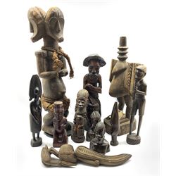 Group of ten carved figures, to include an African three-headed carved figure with plaited   accessories, H63cm, a carved Calao Ceremonial bird, Senufo, Ivory Coast, Liberia, together with other similar carved wooden figures (10)