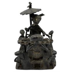 Nigerian Benin bronze group depicting a seated Oba eating under a parasol, another seated figure opposite and children, on rectangular base, H13cm x W14cm