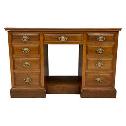 Edwardian walnut twin pedestal kneehole desk, rectangular top over central frieze drawer flanked by eight graduating drawers, on plinth base