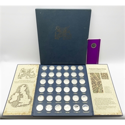 'Betjeman's Bygone Britain', a collection of thirty-six hallmarked sterling silver medallions by John Pinches from a strictly limited edition issue of 1266, depicting landmarks which have vanished from the face of Britain as selected by Sir John Betjeman, housed in a bespoke presentation folder and outer cover, with certificates and information leaflets, together with an additional 'Chain Pier, Brighton' medallion housed in a unopened card folder, each medallion weighs 33.5 grams