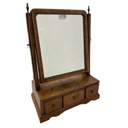 Early 18th century walnut swing mirror, rectangular plate with moulded uprights, fitted with three oak lined drawers with satinwood stringing supported by a shaped plinth base 