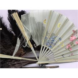 A group of early 20th century parasols including an ivory handled example, bamboo and others, together with three fans including a black ostrich feather fan with faux tortoiseshell sticks  