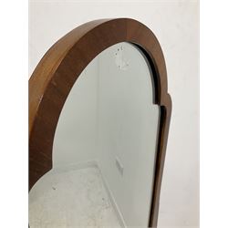 Edwardian mahogany framed cheval mirror, the arched mirror on square tapered uprights, raised on splayed supports with brass castors 
