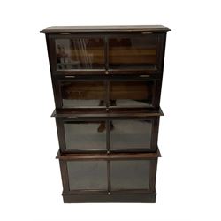 Early 20th century mahogany Globe Wernicke design stacking library bookcase, four tier, each enclosed by glazed up-and-over doors, on plinth base