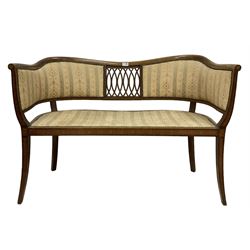 Edwardian mahogany and satinwood banded settee, shaped rail with pierced central splat, upholstered with stud detail, on tapering splayed supports