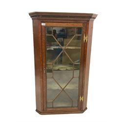 Georgian oak corner cabinet, the dentil cornice over single glazed door with astragal design enclosing interior with three fitted shelves W76cm