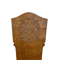 'Gnomeman' pair oak hall chairs, the shaped back carved with flower head motif and carved with gnome signature, on three supports, the seat, back and rear support adzed, by Thomas Whittaker of Little Beck, Whitby 