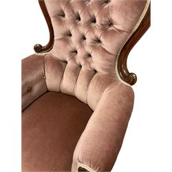 Victorian armchair, the scrolled show frame over buttoned back pink fabric, raised on cabriole supports, terminating in castors