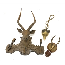 Brass fox head door stop H40cm, iron deer head wall rack W51cm, brass stag head pen rack on circular base and a fox head inkwell 